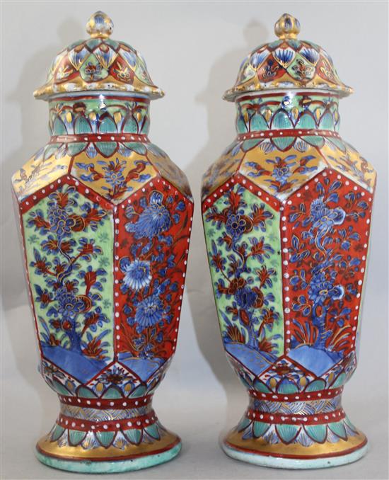 A pair of Chinese hexagonal baluster clobbered vases and covers, 18th century and later, 31.5cm